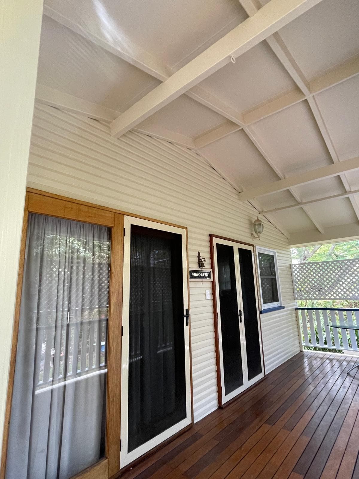 Bright covered veranda with cream weatherboards